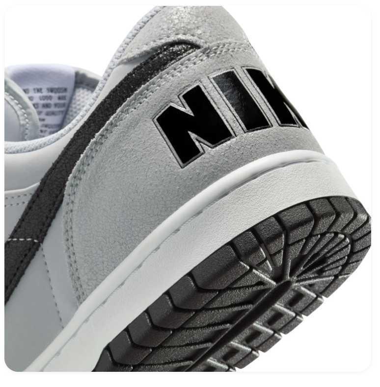 Nike Light Grey Low-Top Sneakers with Black Swoosh and Bold Heel Logo
