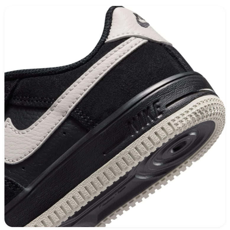 Nike Black Low-Top Sneakers with Cream Swoosh and Two-Tone Sole